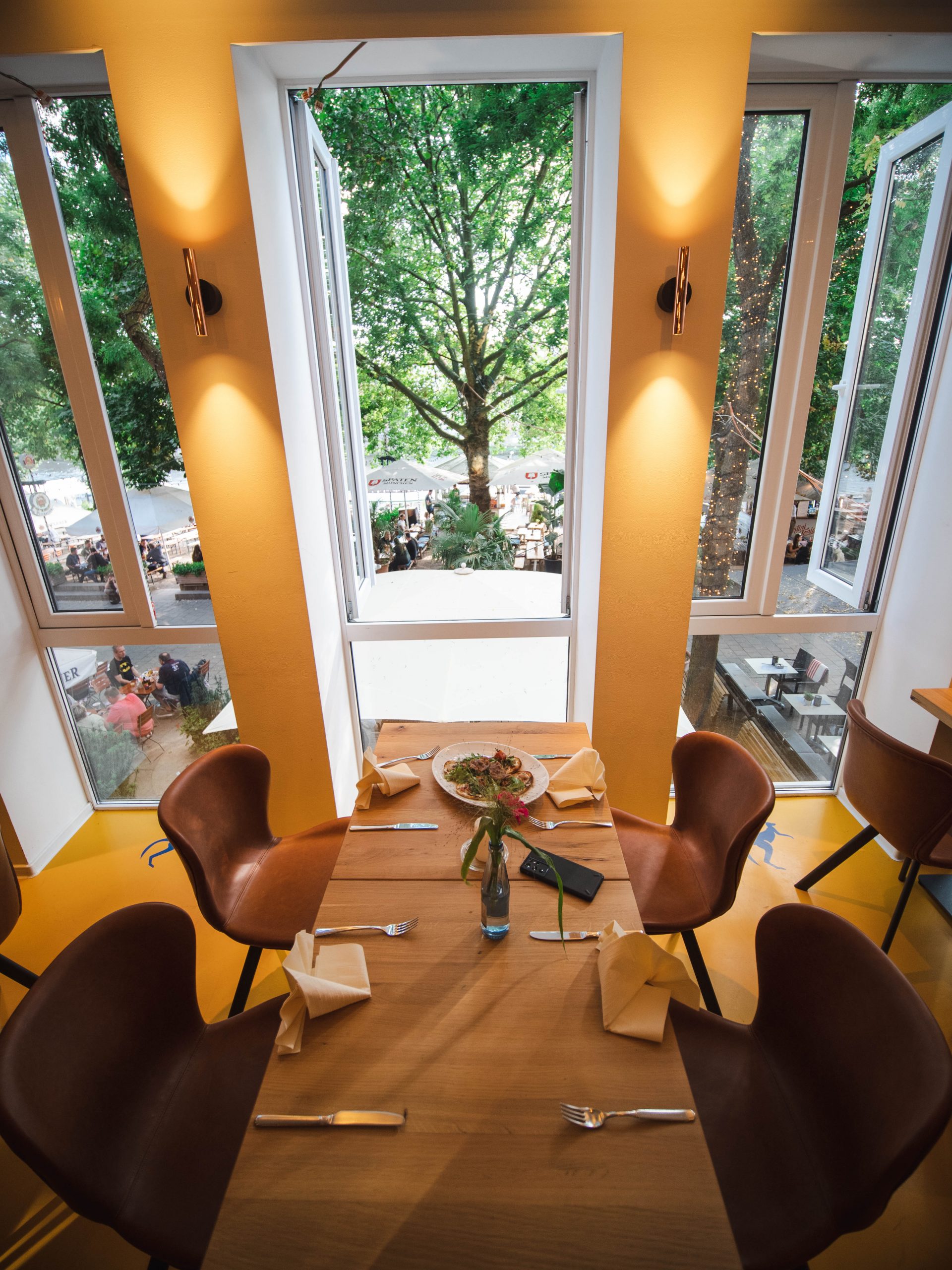 Laid table at the open window with a view of the terrace