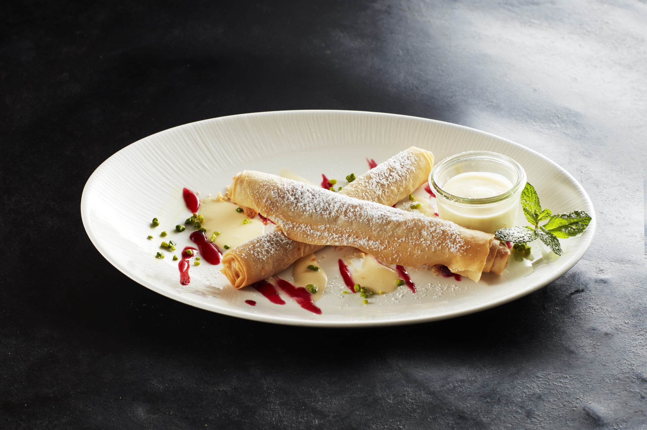Dessert with berry sauce and cream